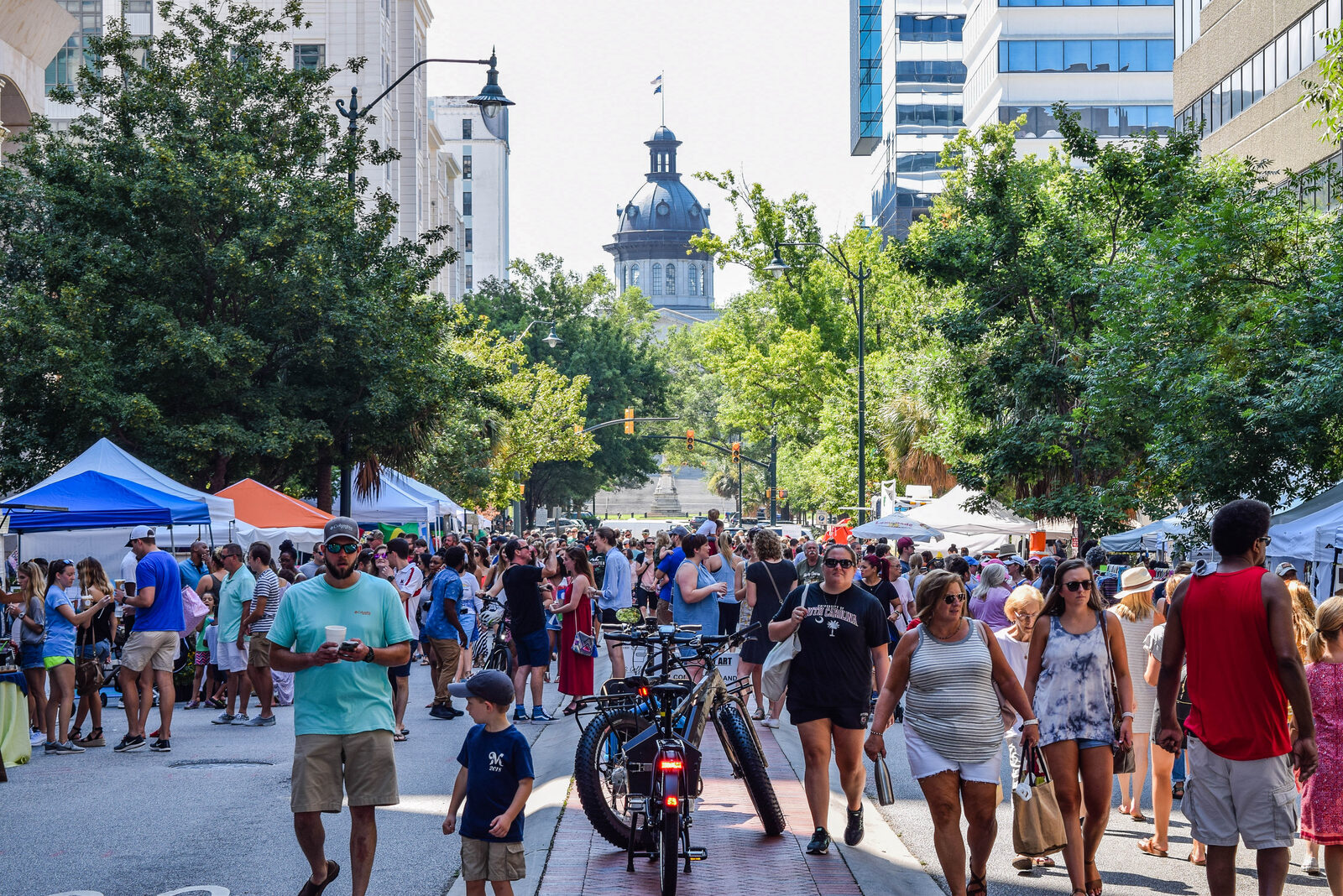 Saturday crowds at Soda City Market on Main Street, with the State House dome at the end of the street